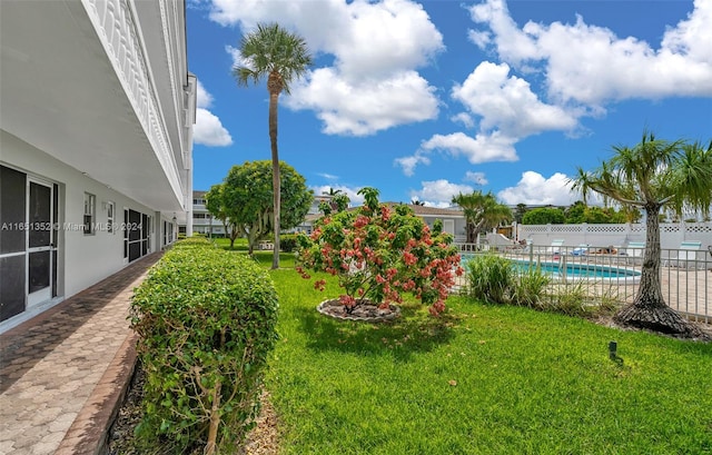 view of yard with a fenced in pool