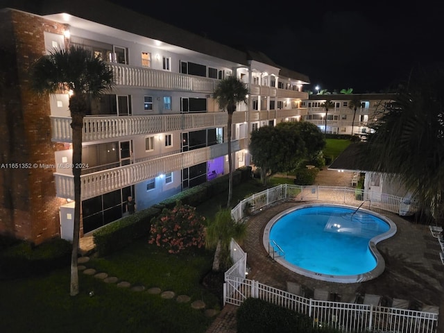 view of pool at night