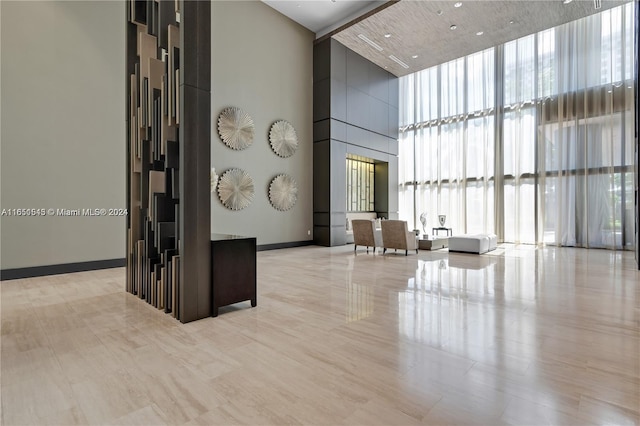 5252 NW 85th Ave Unit 1909, Doral, FL 33166 - community lobby featuring a towering ceiling and a wall of windows