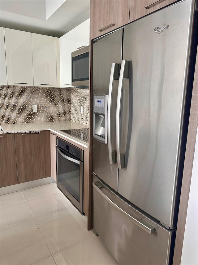 5252 NW 85th Ave Unit 1909, Doral, FL 33166 - kitchen with appliances with stainless steel finishes, modern cabinets, white cabinets, tasteful backsplash, and light countertops
