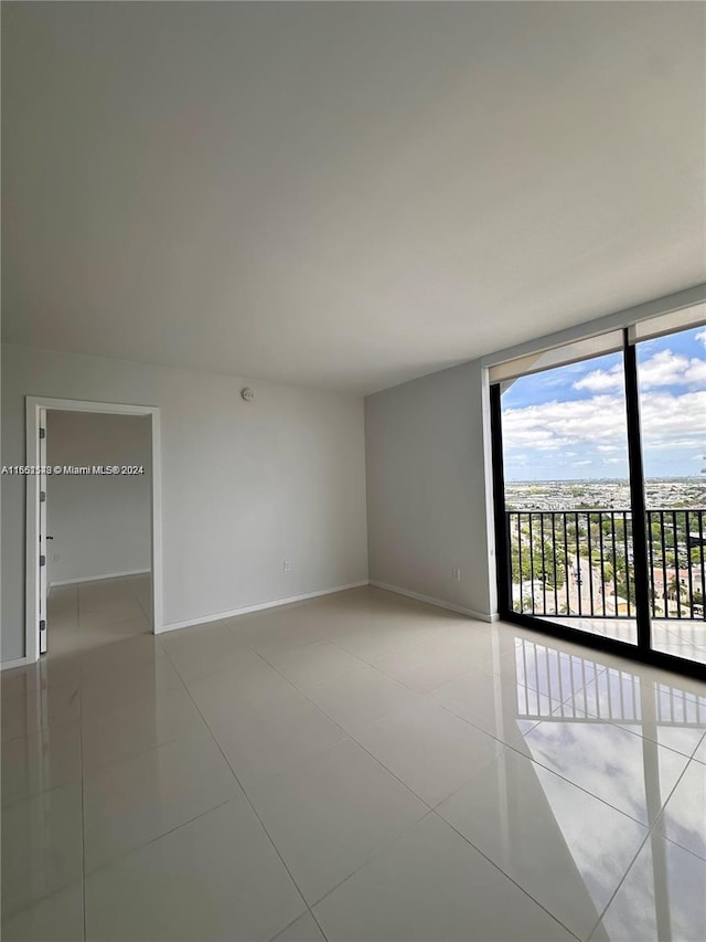 tiled spare room with expansive windows