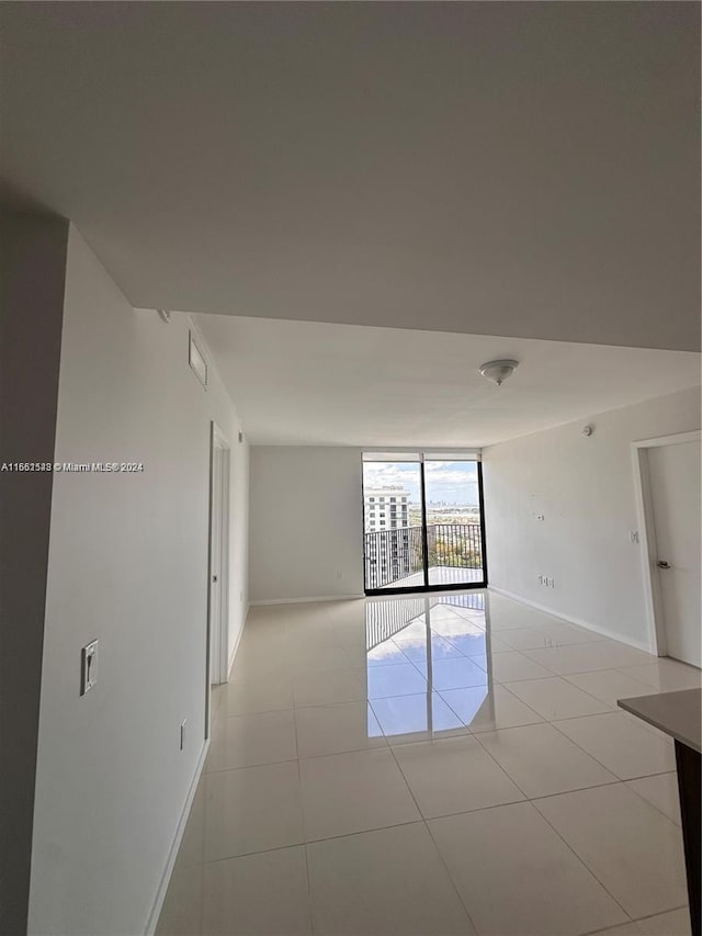 5252 NW 85th Ave Unit 1909, Doral, FL 33166 - unfurnished room featuring floor to ceiling windows, baseboards, and light tile patterned flooring