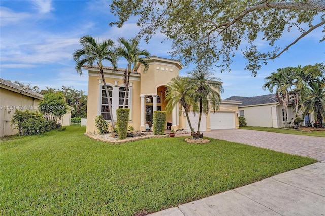 mediterranean / spanish-style home with a front yard and a garage