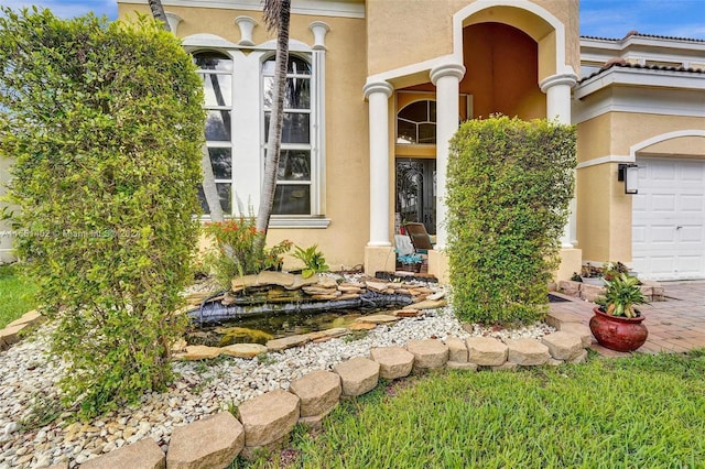 view of exterior entry with a garage