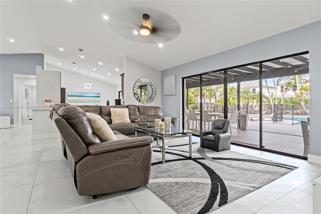 living room with lofted ceiling, ceiling fan, and light tile patterned flooring