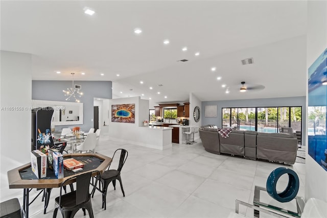 dining area featuring vaulted ceiling and a chandelier