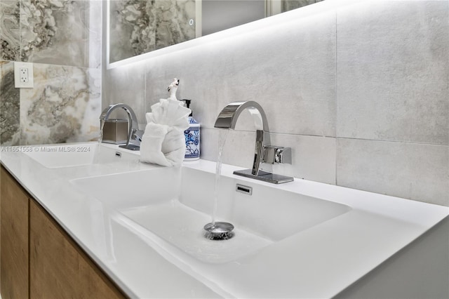 interior details with vanity and backsplash