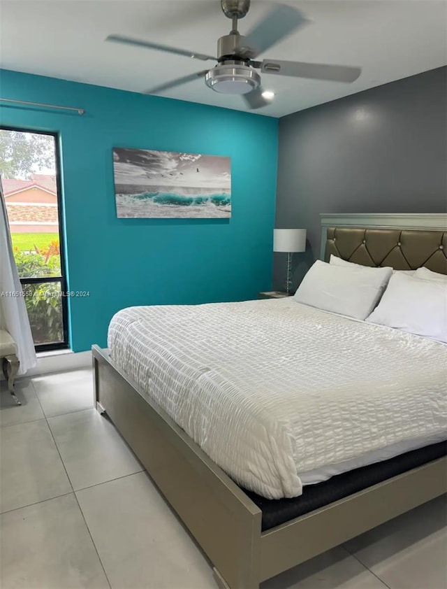 tiled bedroom featuring ceiling fan