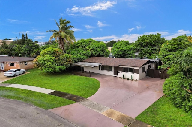 770 NW 175th Dr, Miami Gardens, FL 33169 - ranch-style house with stucco siding, concrete driveway, a front lawn, and fence