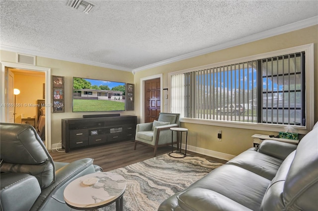 living room with ornamental molding, dark wood-type flooring, a textured ceiling, and plenty of natural light