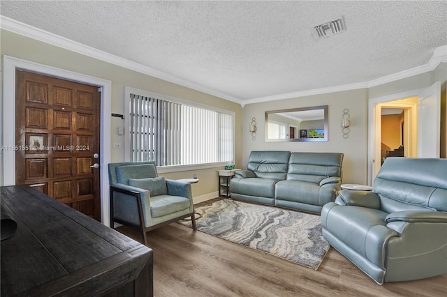 living room featuring ornamental molding, a textured ceiling, and hardwood / wood-style flooring