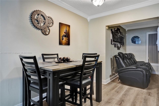 dining area featuring crown molding, a textured ceiling, and hardwood / wood-style flooring