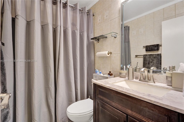 bathroom with toilet, crown molding, vanity, curtained shower, and tile walls