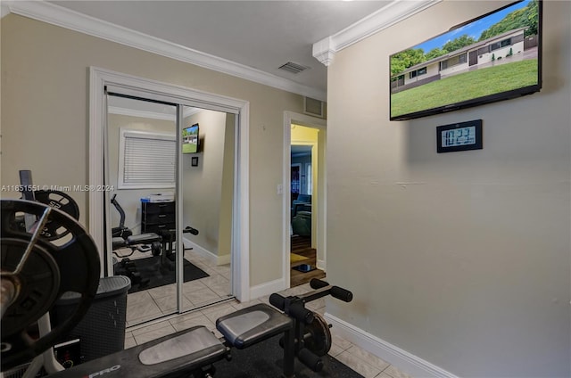 workout room with crown molding and light tile patterned flooring