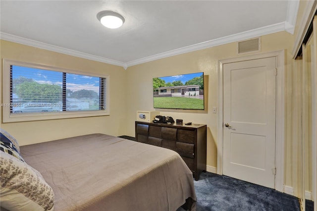 bedroom featuring crown molding and dark carpet