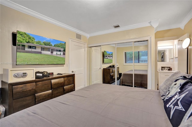 bedroom featuring crown molding and a closet