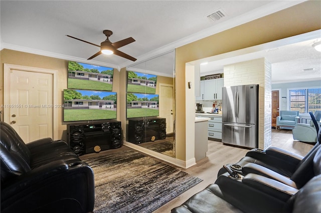 living room with light wood-type flooring, ceiling fan, and ornamental molding