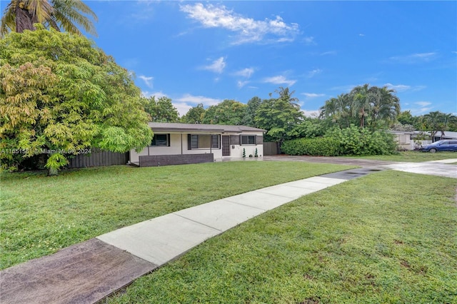 ranch-style house featuring a front lawn