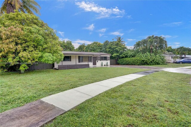 770 NW 175th Dr, Miami Gardens, FL 33169 - ranch-style house with driveway, a front lawn, and fence