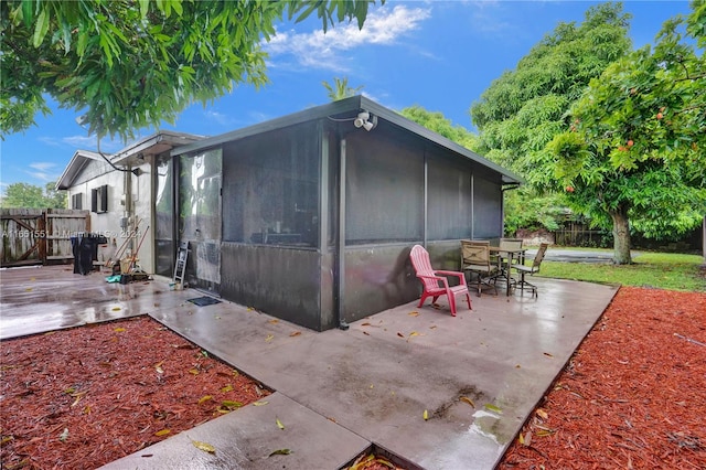 exterior space featuring a patio area and a sunroom