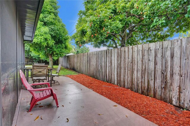 770 NW 175th Dr, Miami Gardens, FL 33169 - view of patio / terrace featuring outdoor dining area and a fenced backyard