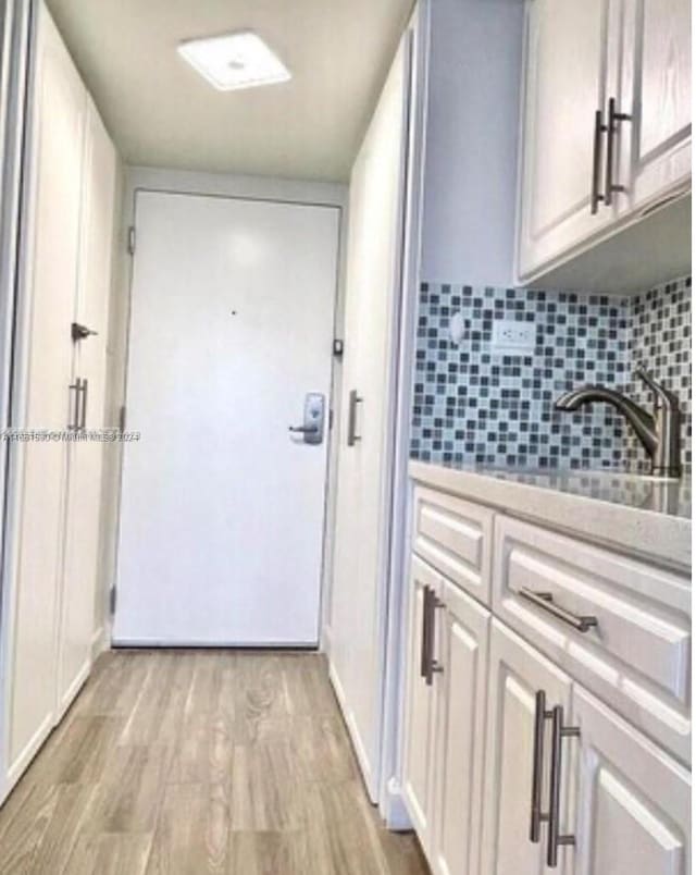 doorway with light hardwood / wood-style flooring and sink