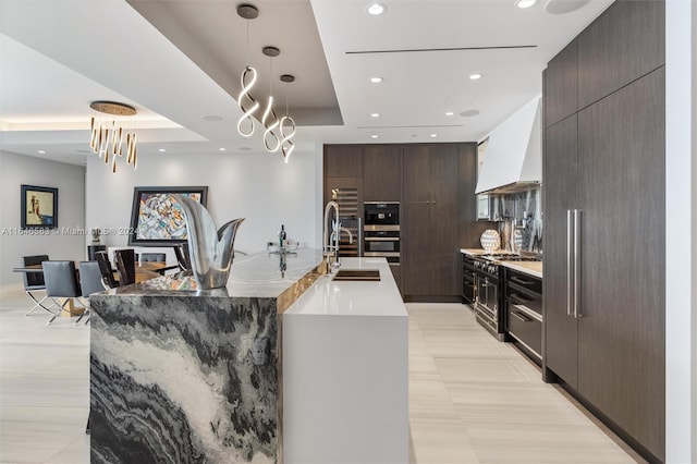 kitchen featuring custom exhaust hood, dark brown cabinets, modern cabinets, and a raised ceiling