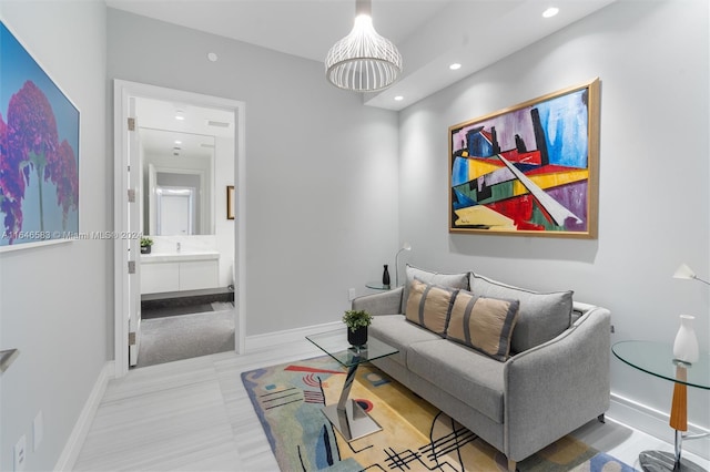 living area featuring recessed lighting and baseboards