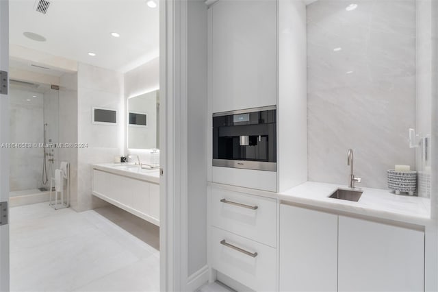 bathroom with vanity, visible vents, recessed lighting, a shower stall, and tile walls