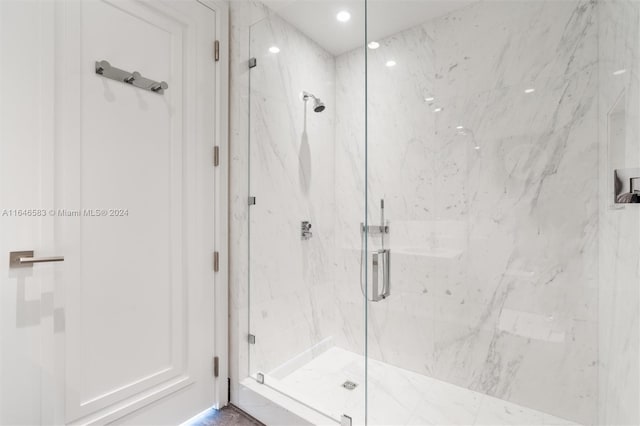 full bathroom with a marble finish shower