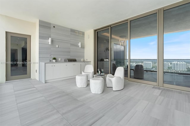 bathroom with a wall of windows and a sink