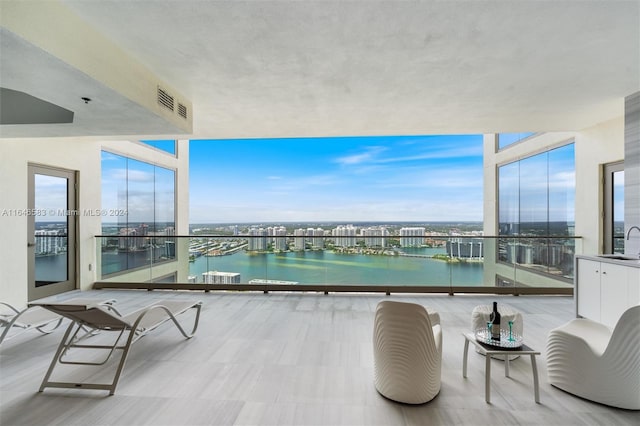 balcony with a sink, visible vents, and a water view