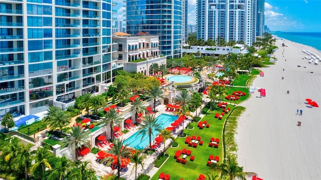 balcony with a water view, a city view, and a view of the beach