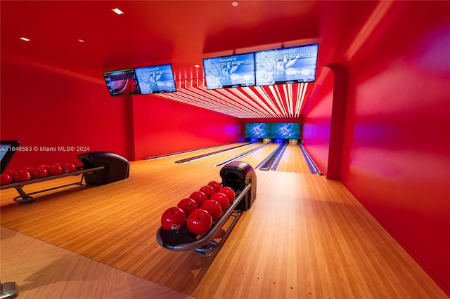 playroom with a bowling alley and wood finished floors