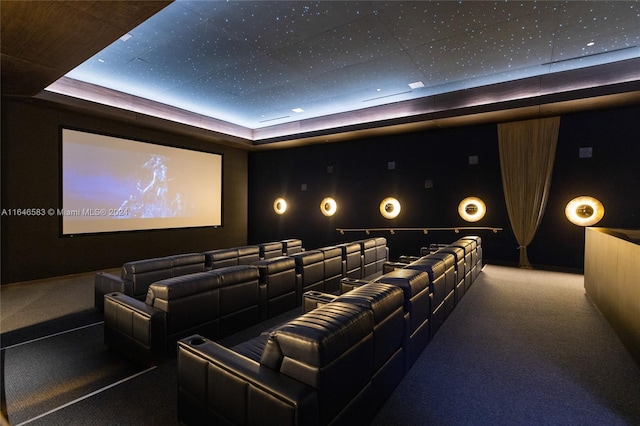 carpeted cinema with a raised ceiling