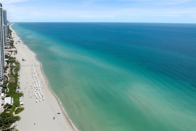 birds eye view of property with a beach view and a water view