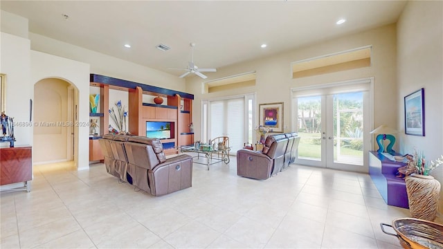 living room featuring french doors, light tile patterned floors, and ceiling fan