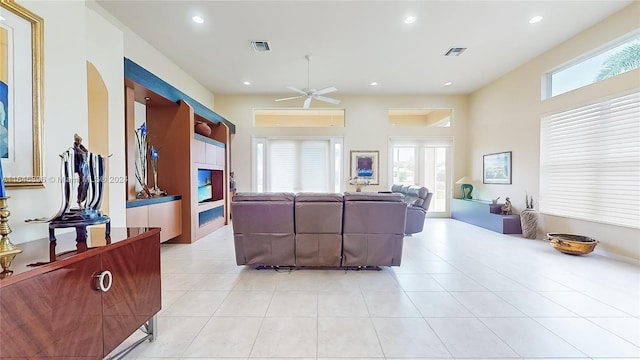 interior space featuring ceiling fan and a fireplace