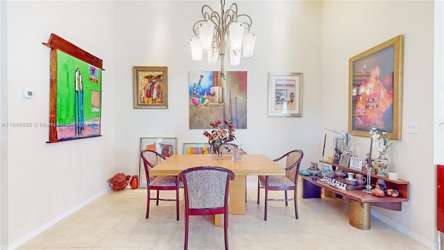 dining area with light tile patterned floors and a chandelier