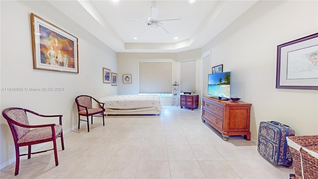 tiled bedroom featuring a tray ceiling and ceiling fan