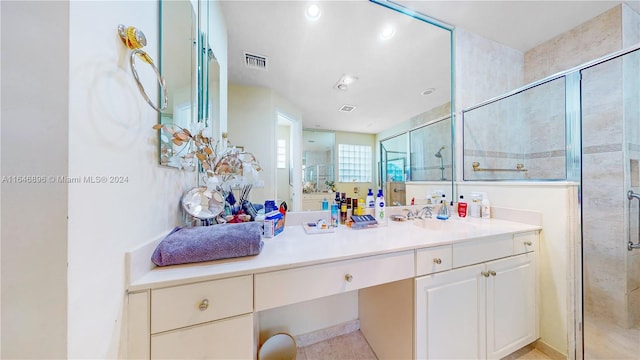 bathroom featuring vanity and an enclosed shower