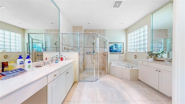 bathroom featuring vanity, plus walk in shower, and tile patterned floors