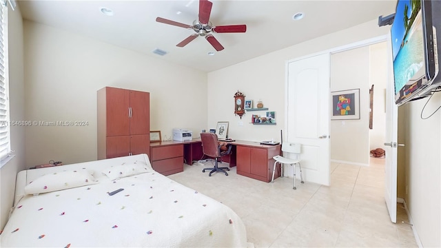 tiled bedroom featuring ceiling fan