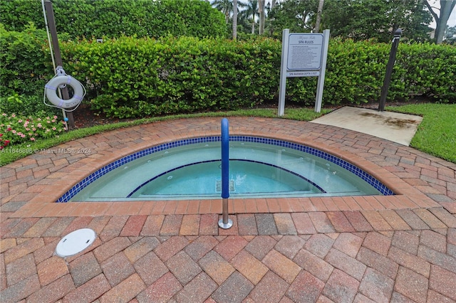 view of swimming pool with a community hot tub