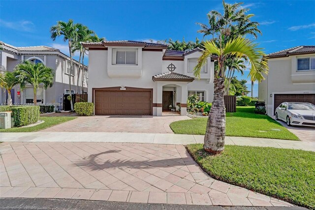 mediterranean / spanish-style home with a garage