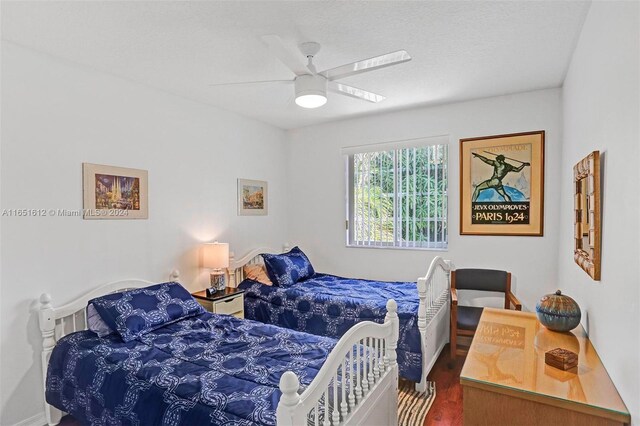 bedroom featuring ceiling fan, a closet, and dark wood-type flooring