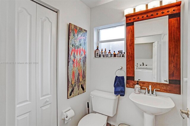 bedroom featuring ceiling fan, ensuite bathroom, and hardwood / wood-style flooring