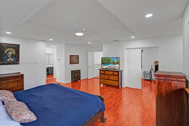 bedroom with ceiling fan, hardwood / wood-style flooring, and ensuite bathroom