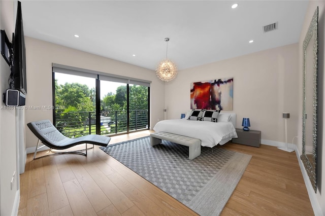 bedroom featuring light wood-type flooring and access to outside