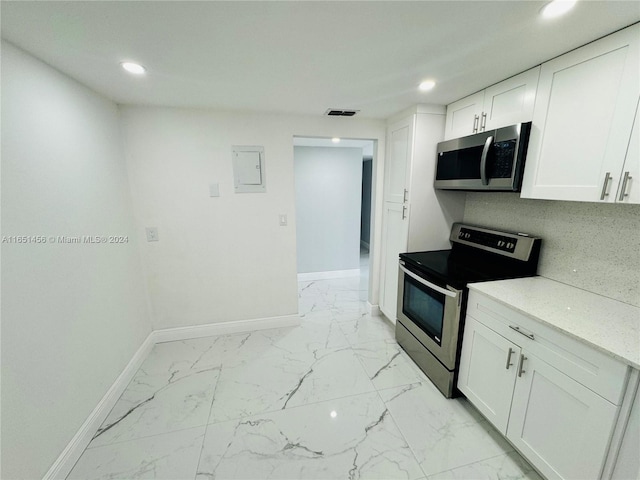 kitchen featuring stainless steel appliances and white cabinetry